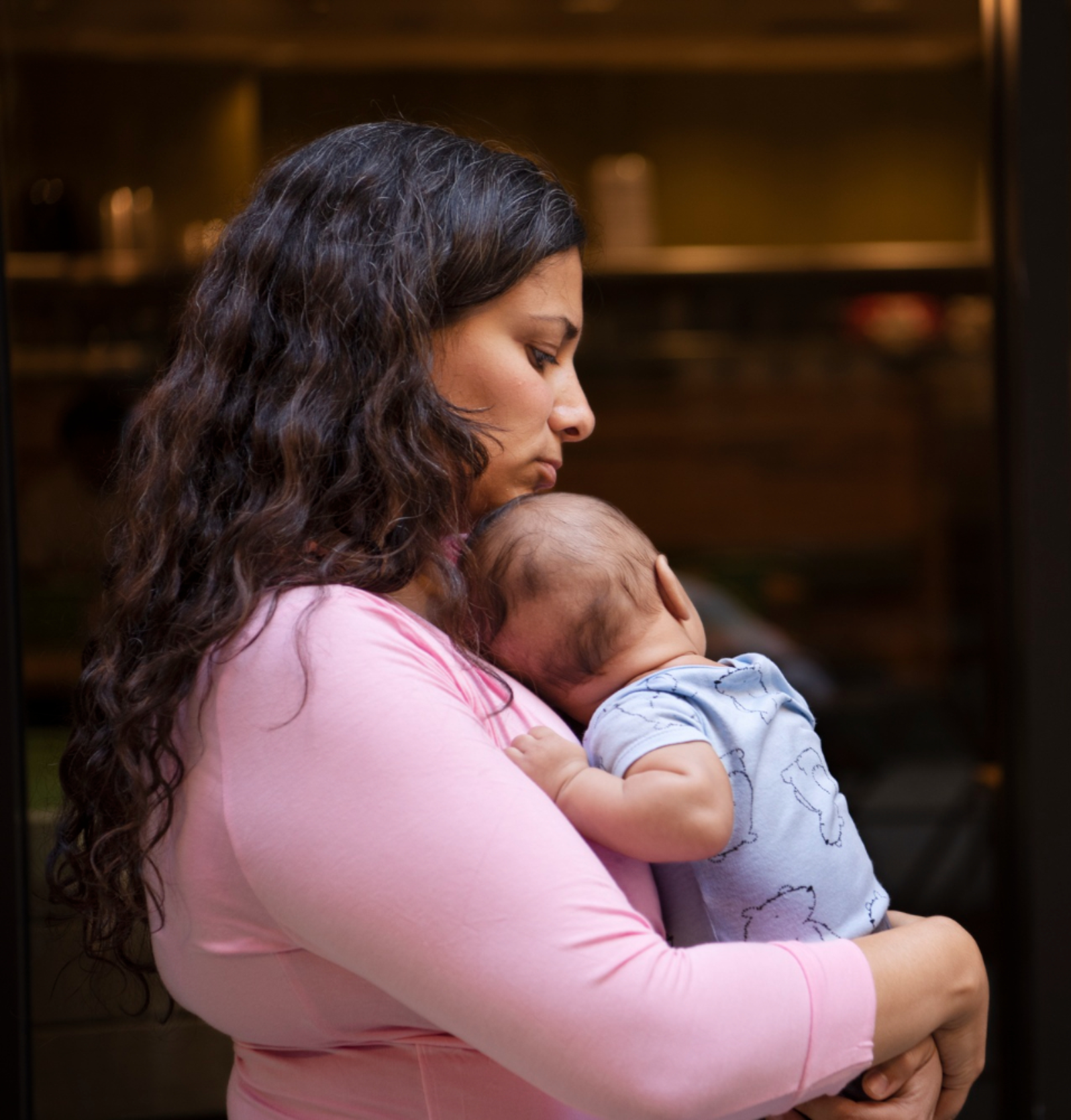 Side view mother holding baby